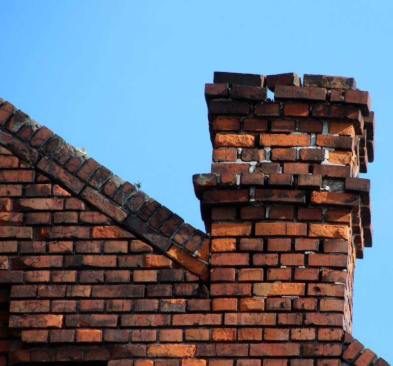Signs Your Corona Del Mar Home Needs a Chimney Inspection Damaged chimney on an Corona Del Mar home showing cracks and missing mortar